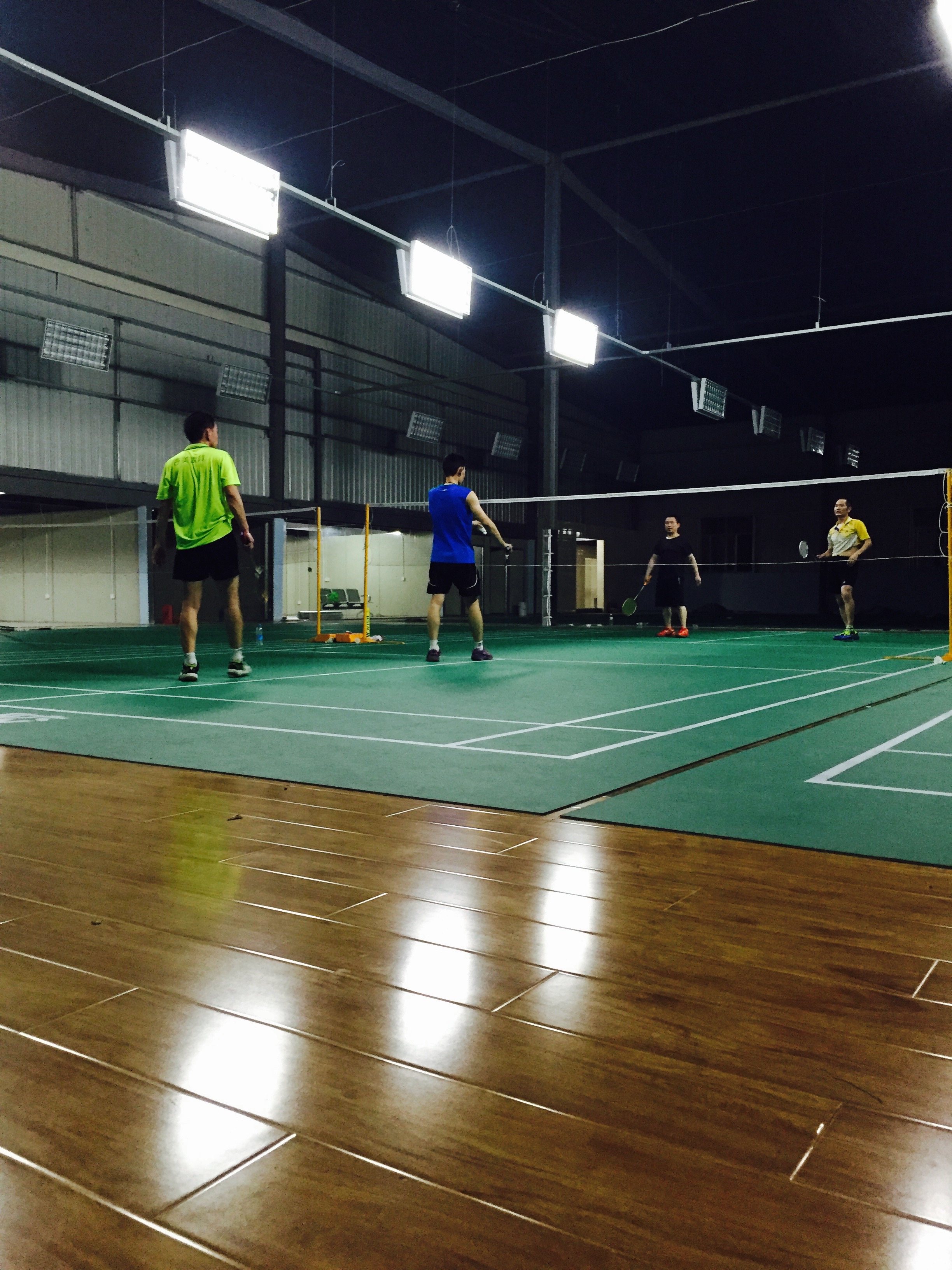 The lighting is on the sides of the court, which is much better than above, and the ceiling is covered in a black material so you can clearly see the birdie. It's little touches like these that make the place so good. 