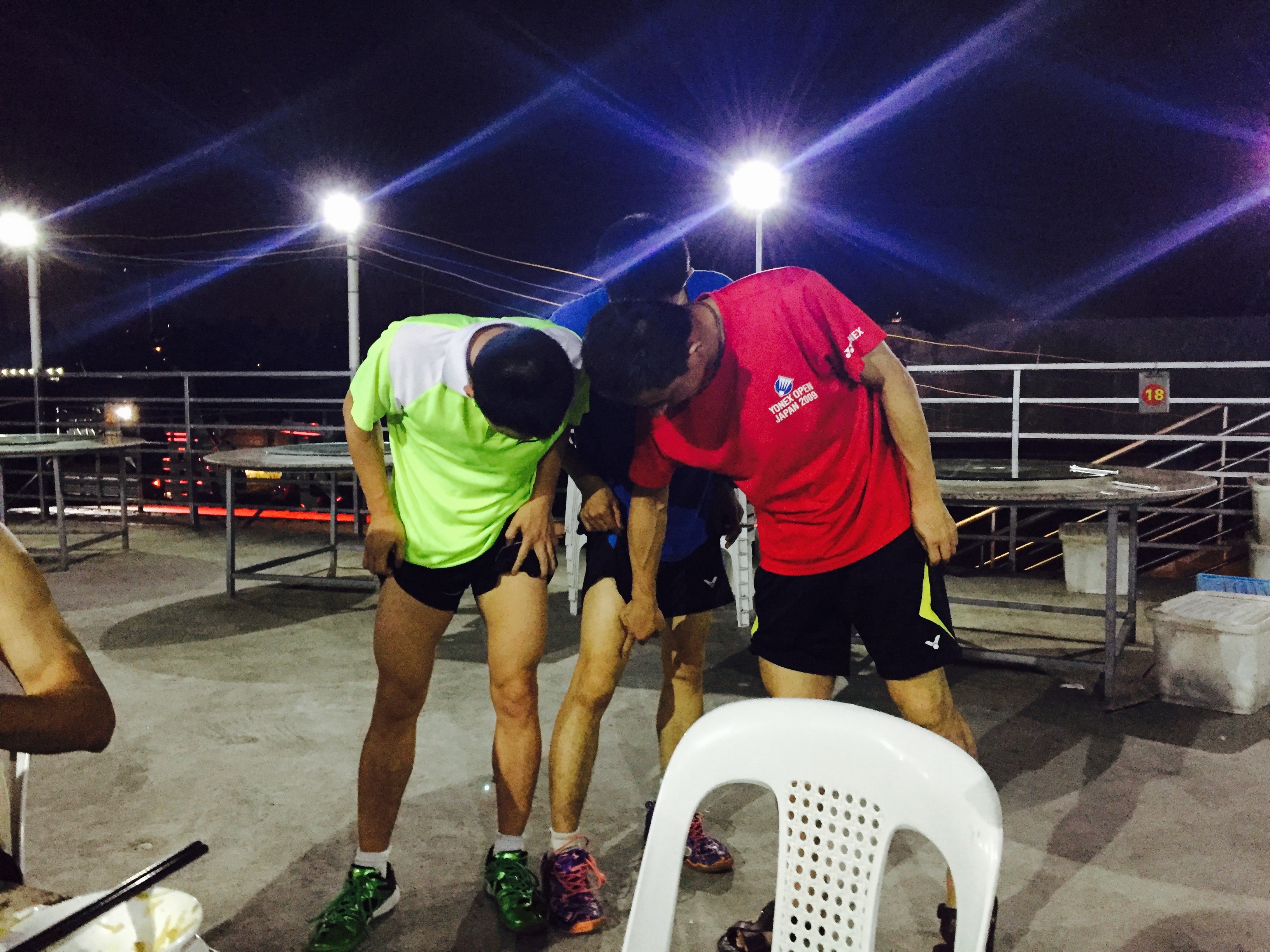 My coach (center), my coaches coach (in the red, and another guy comparing their leg muslces to see which one was bigger. In badminton, the thigh muscle is important and the bigger the better. 